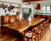Long single-slab live edge suar dining tabletop with a rich, wavy wood grain and organic, natural edges.