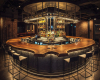 A unique, custom-made circular live edge bar with a rich, swirling suar wood grain is the highlight of this bar.