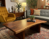 A modern, single-slab suar living room table with a subtle concave curve and a smooth, satin finish.
