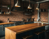 Bespoke waterfall kitchen island with a continuous grain wood top, the centerpiece of a luxury industrial kitchen.