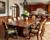 A 10-seater live edge dining tabletop with a boldly defined wood grain and a thick, ink-black natural edge, rendered with a graphic, illustrative quality.