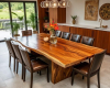 A wide 10-seater dining tabletop with a dramatic, tiger-stripe grain pattern and a gently cascading live edge.