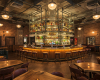 A luxury pub furnished with handcrafted live edge tables that surround a grand, showstopper of a circular bar.