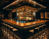 A bespoke, architectural island bar with a thick, straight-edged wood top, the heart of an exclusive luxury club.