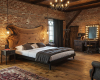 A luxury rustic-chic bedroom's focal point is a statement live edge bed with a unique, wing-shaped suar headboard.