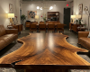 A monumental, bookmatched suar living room table with a perfectly symmetrical grain and a prominent, dark kintsugi-style inlay.