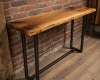 A slim, live edge console table featuring a rich, high-contrast suar wood grain with several dramatic, dark knots.