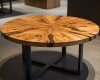 A round coffee table with a mesmerizing starburst grain pattern radiating from the center of the richly colored suar wood.
