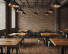 The authentic atmosphere of a rustic-industrial restaurant, furnished with solid wood tables and metal chairs.