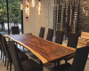 An elegant 10-seater live edge dining tabletop with a dramatic contrast wood grain, featuring a gracefully undulating natural edge.
