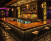 A custom-made, straight-edged wood bar with a warm, polished grain, creating an anchor in this upscale lounge bar.