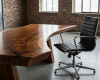 A luxury modern office's focus is a unique, custom-shaped live edge desk with a beautiful ergonomic curve.