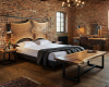 A handcrafted live edge suar wood bed featuring a unique, rail-mounted headboard in a luxury rustic bedroom.