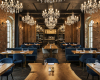 The opulent setting of a grand luxury restaurant, with bespoke live edge tables and blue velvet seating.