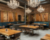 A unique restaurant design where live edge tables are complemented by matching, large-scale suar wood wall panels.