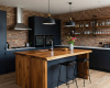 A luxury industrial kitchen's focus is a waterfall island with a live edge suar top and dark blue cabinets.